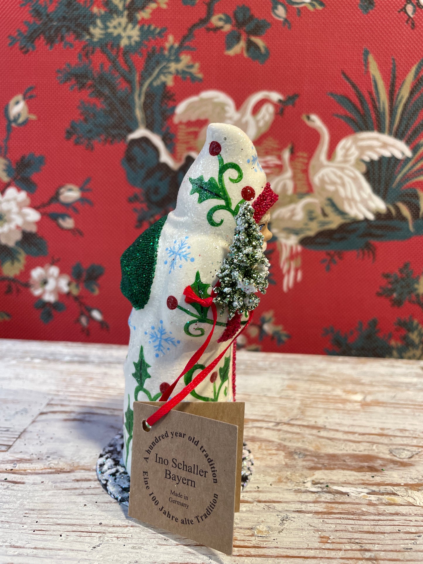 Cream Coat Santa Holding Tree | Ino Schaller