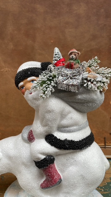 White Glitter Santa with Black Beaded Trim & Bag of Toys on Polar Bear | Ino Schaller