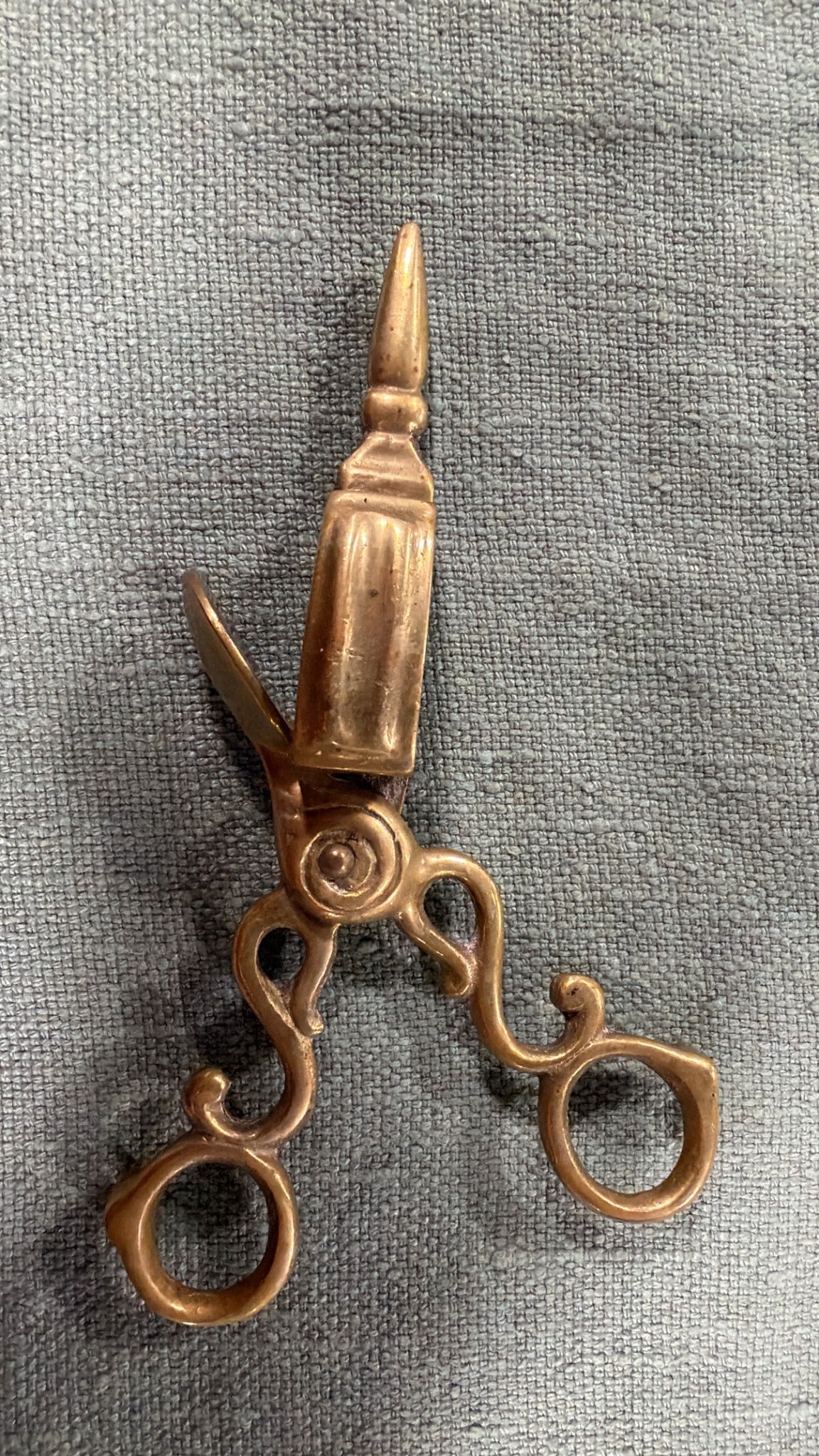 Vintage brass wick trimmer, 17 cm long, with flowing scroll handles, round finger loops and a raised rectangular wick-catching box