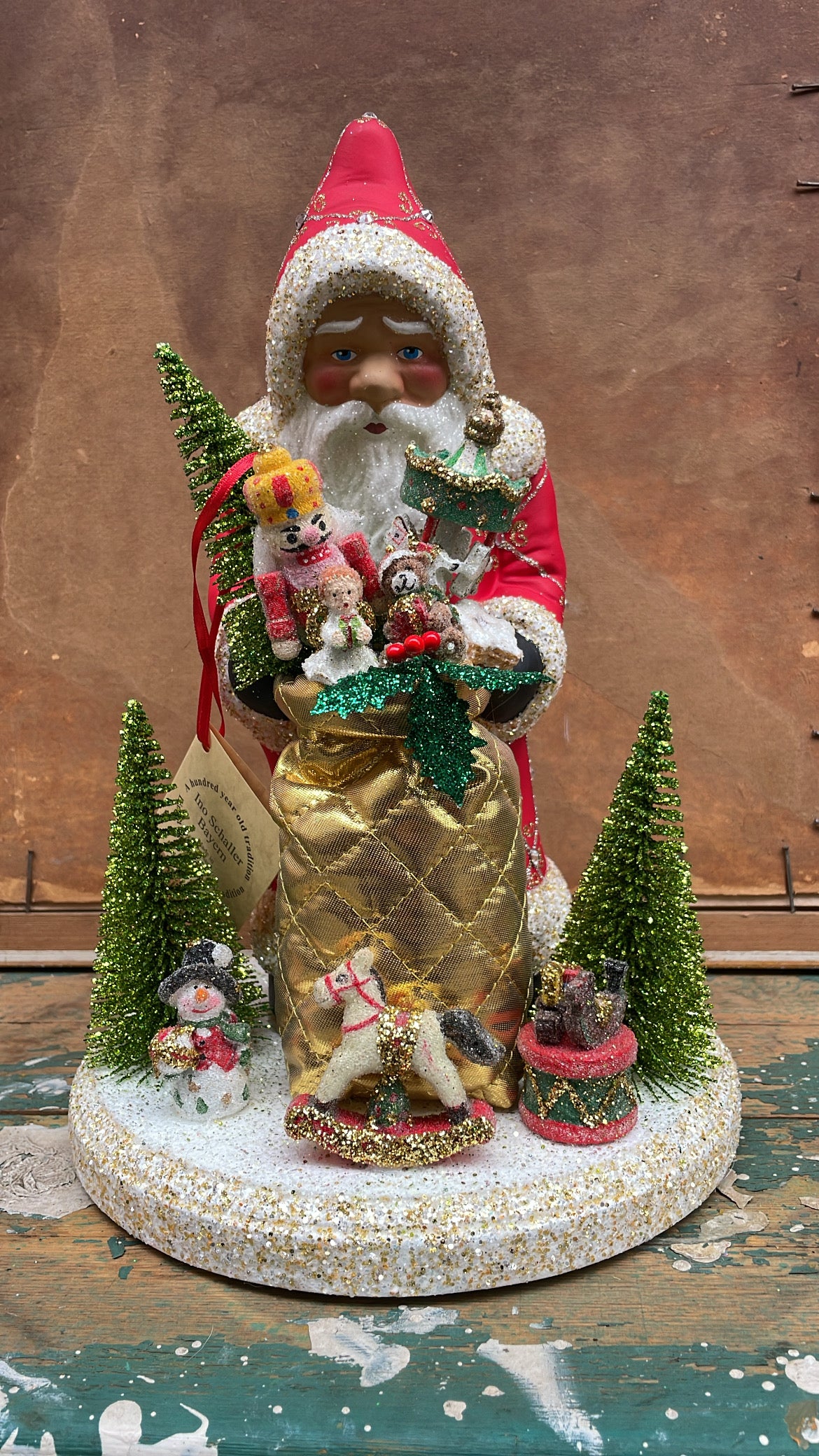 Postpox Red Santa with Gold & Silver Decoration & Crystals, Soft Gold Bag with Toys on Display | Ino Schaller