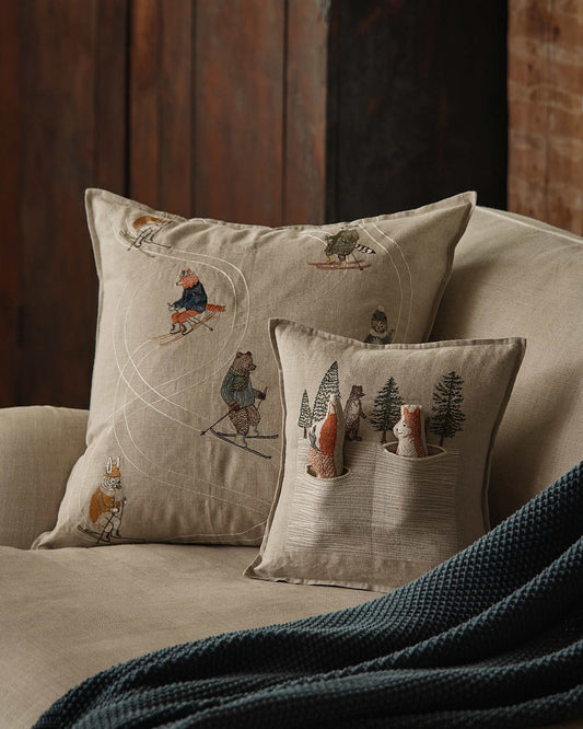 Downhill Skiers Pillow by Coral & Tusk in a winter interior