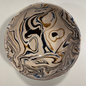 A ceramic bowl with a marbled pattern featuring white, dark blue, yellow ochre, and black colors.