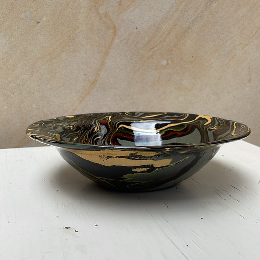 Ceramic bowl with marbled design on a white surface