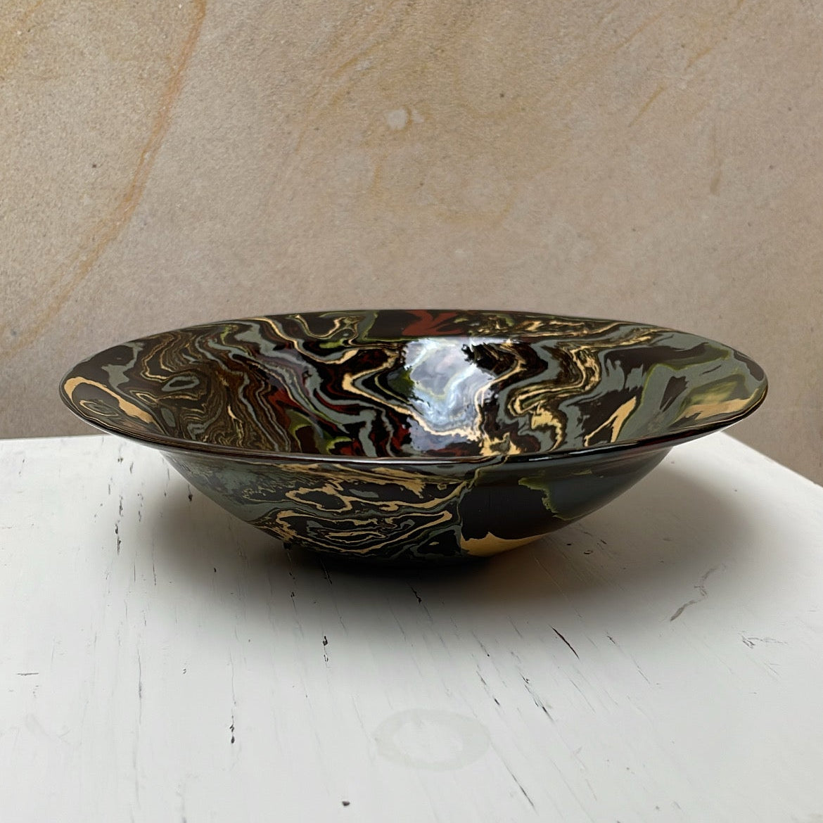 Decorative bowl with marbled design on a white surface