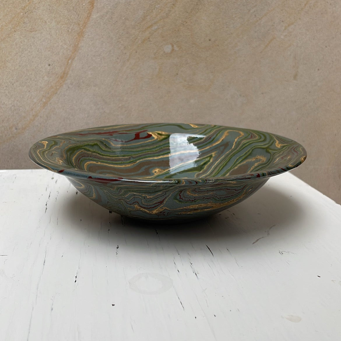 Decorative bowl with marbled pattern on a white surface
