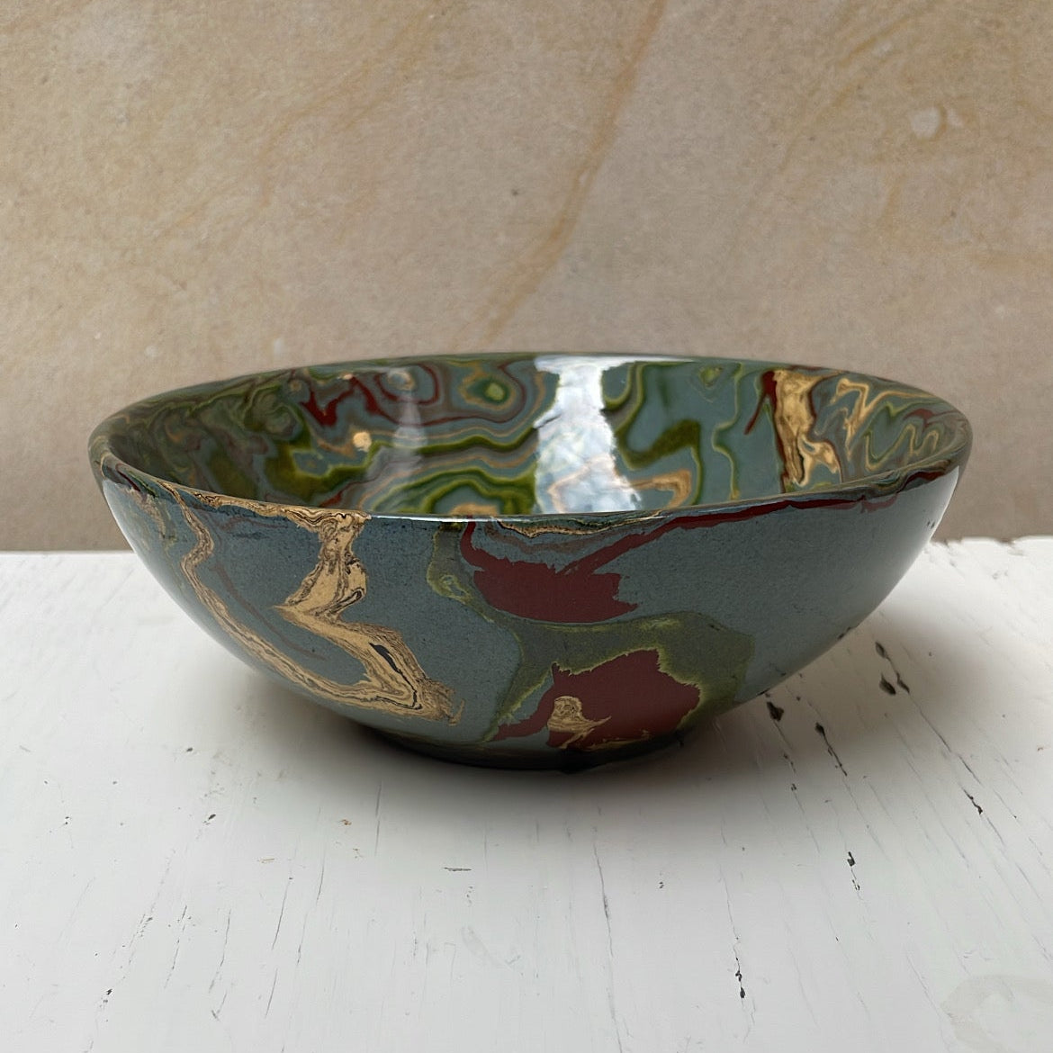Decorative ceramic bowl with floral patterns on a white surface