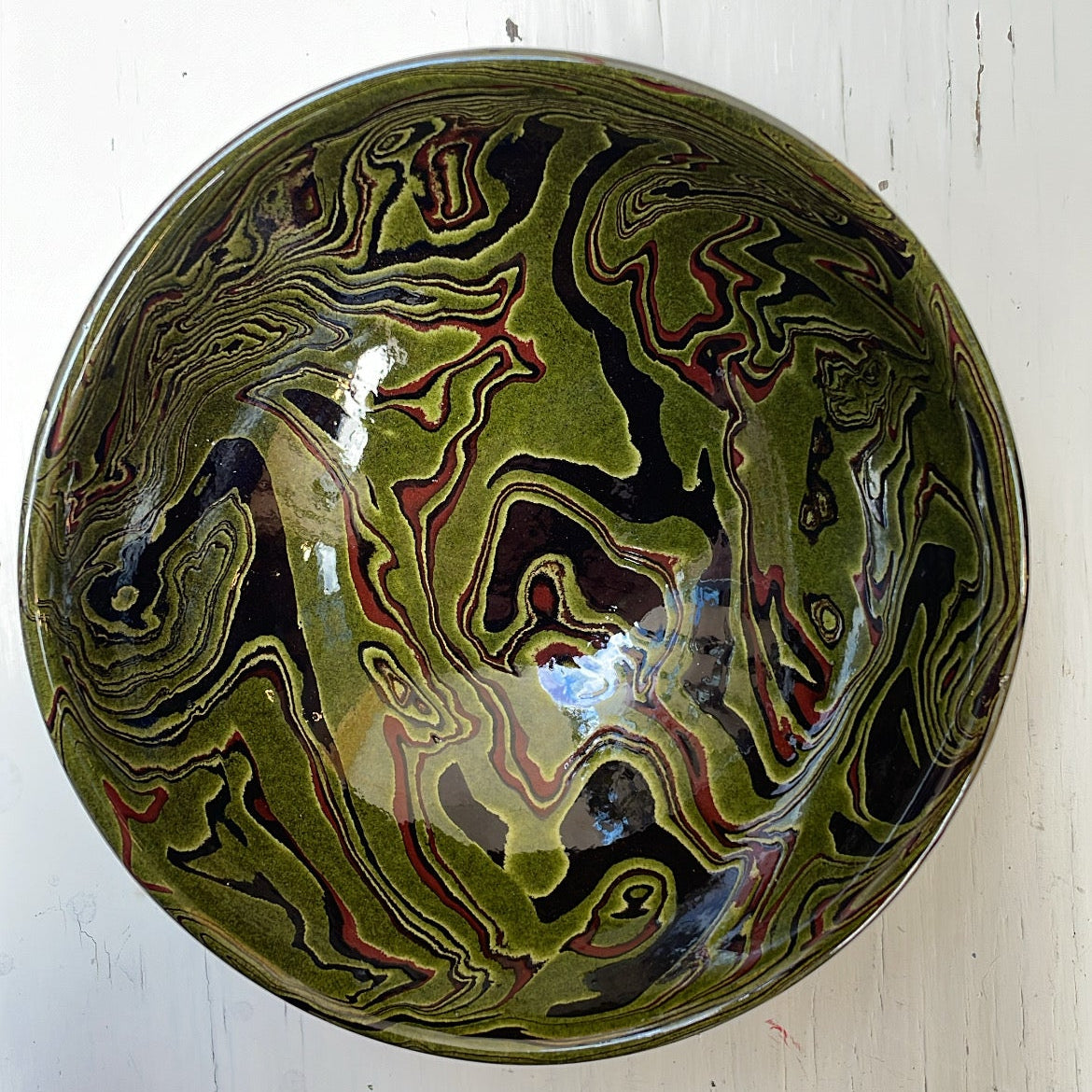 Decorative ceramic bowl with marbled design on a white background