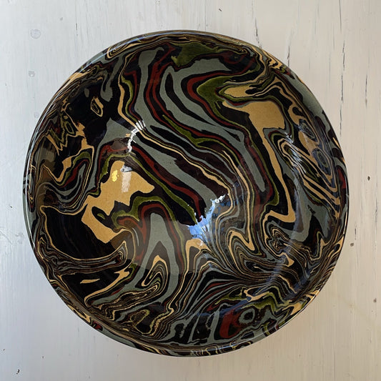 Marbled ceramic knob on a white wooden surface