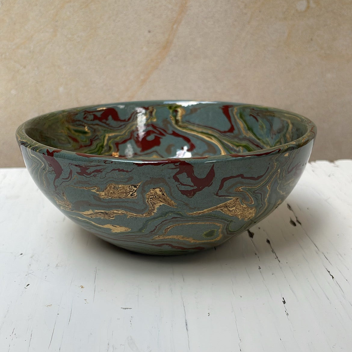 Ceramic bowl with marbled design on a white surface