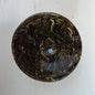 Round ceramic dish with marbled design on a white background