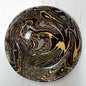 Round decorative item with marbled design on a white background