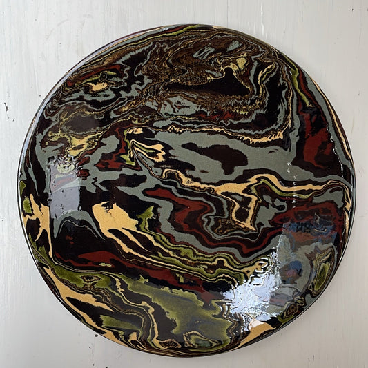 Marbled ceramic plate on a white wooden surface