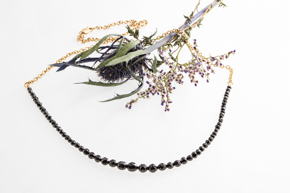 Mikkel Brøgger black diamond necklace styled with thistle and delicate purple flowers