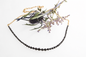 Mikkel Brøgger black diamond necklace styled with thistle and delicate purple flowers