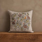 Coral & Tusk Partridge in a Pear Tree pillow styled on a wooden surface