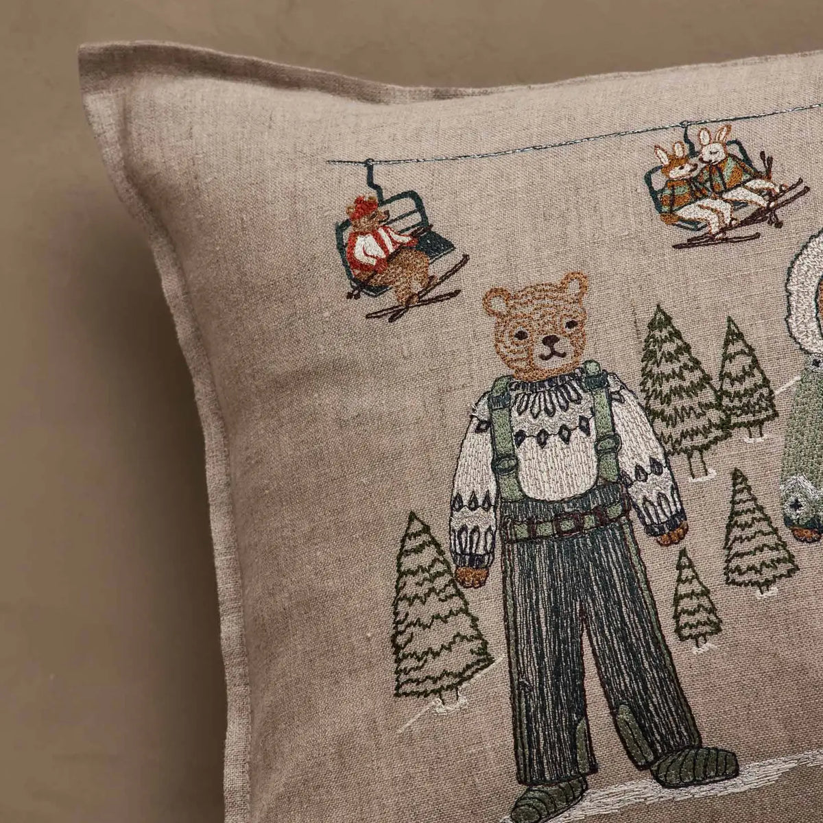 Bear and ski lift embroidery detail on the Coral & Tusk Ski Slope pillow
