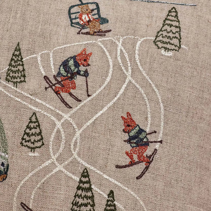 Downhill skiers embroidery detail on the Coral & Tusk Ski Slope pillow