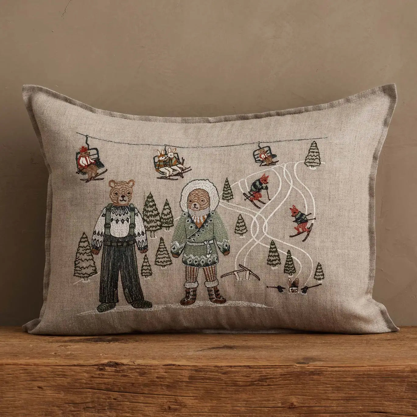 Coral & Tusk Ski Slope pillow styled on a wooden surface