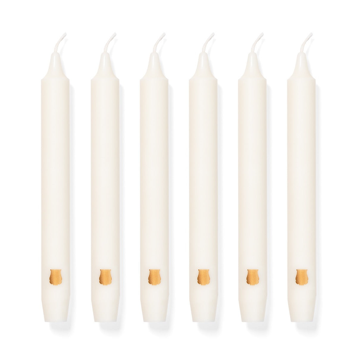 Six ivory Trudon Nazareth Scented Madeleines taper candles with gold emblems