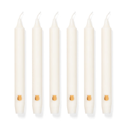 Six ivory Trudon Nazareth Scented Madeleines taper candles with gold emblems