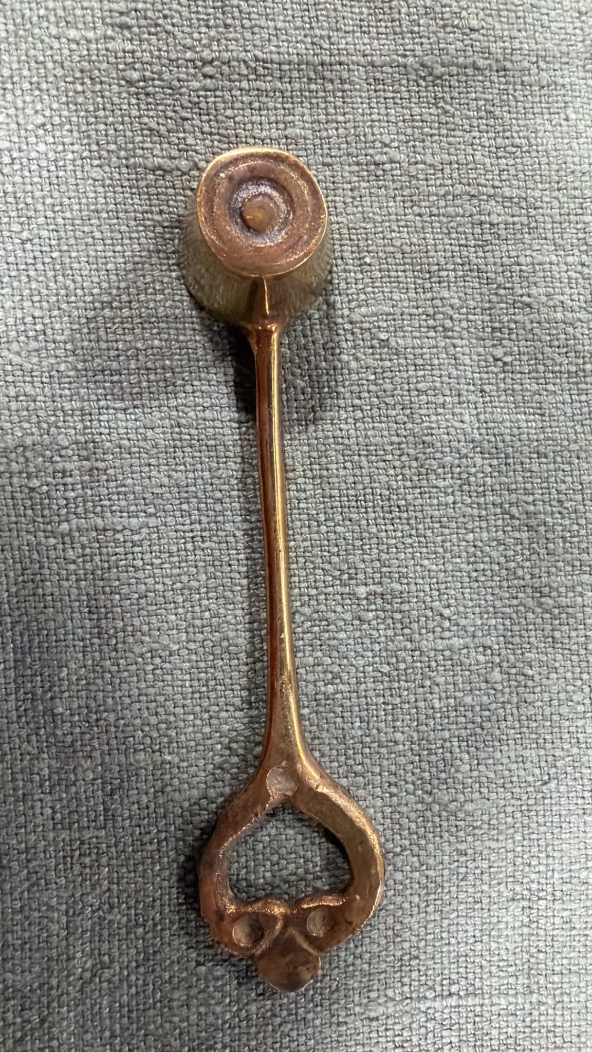 Vintage brass candle snuffer with round bell head and heart-shaped handle, 15 cm long