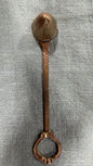 Vintage brass candle snuffer with patterned rounded head, textured stem and decorative ring handle, 20 cm long